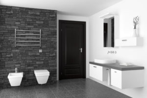 modern bathroom with black stone wall and white equipment